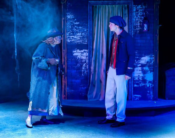 Maddie Beer-Penwell, as the Beggar Woman, and Drew Owens as Anthony Hope meet on the Streets of London. 